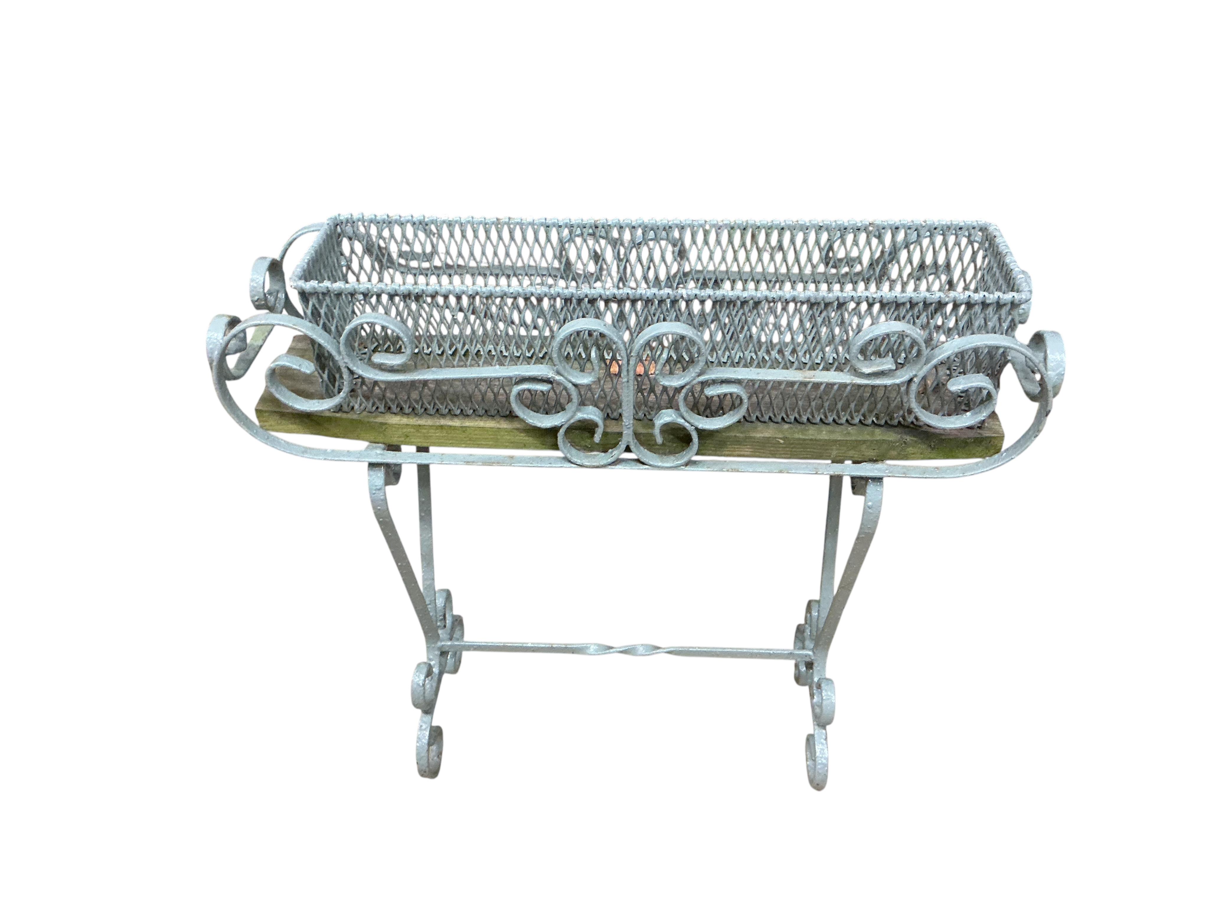 Three painted wrought pot stands, largest width 68cm, height 65cm
